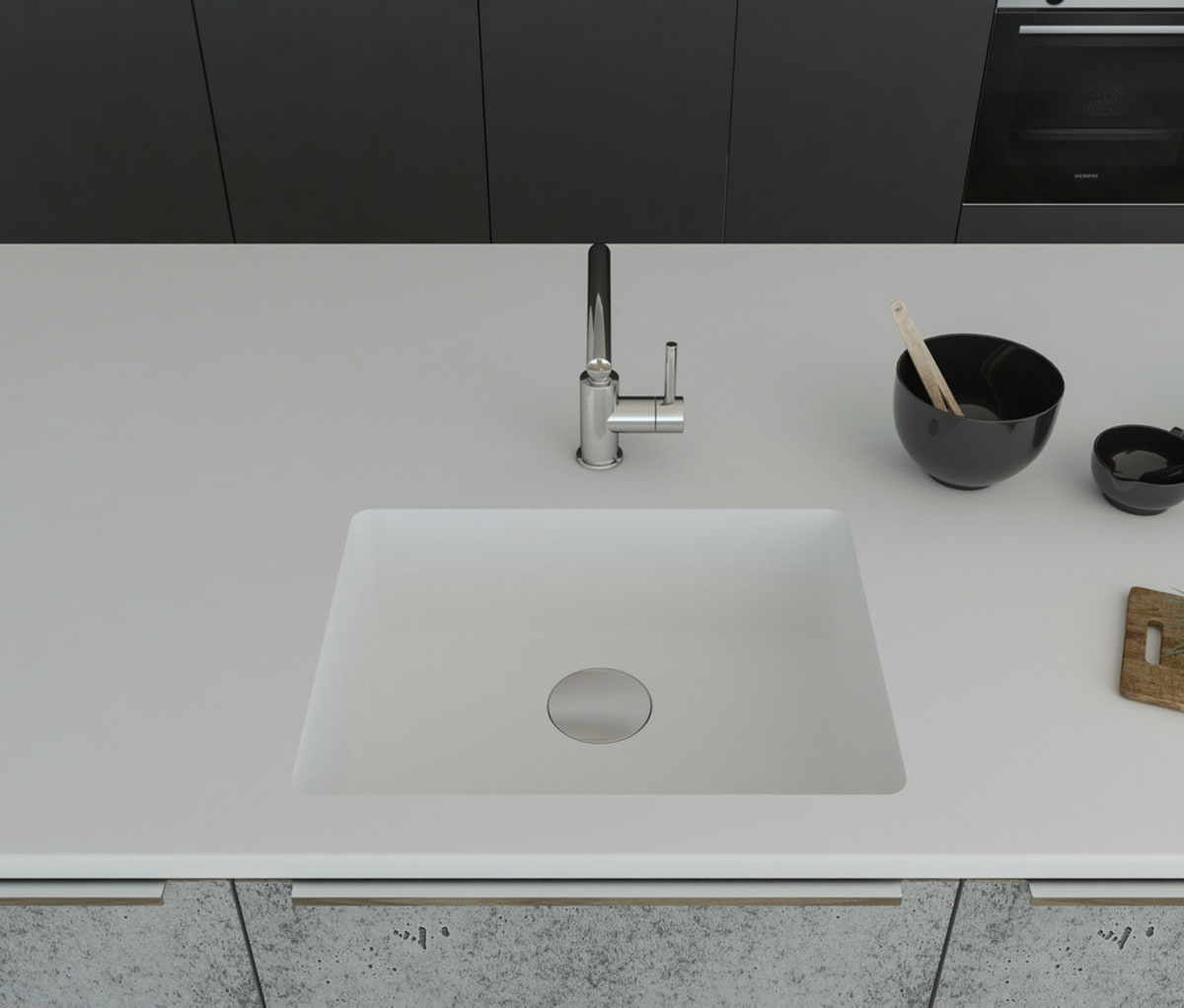 Gegossene Spüle B1212 mit Staronboden in Bright White mit Ablaufgarnitur AH1, welche separat bestell bar ist. Die Spüle ist in eine Arbeitsplatte in Bright White eingelassen. Breite 581 mm, Tiefe 451 mm