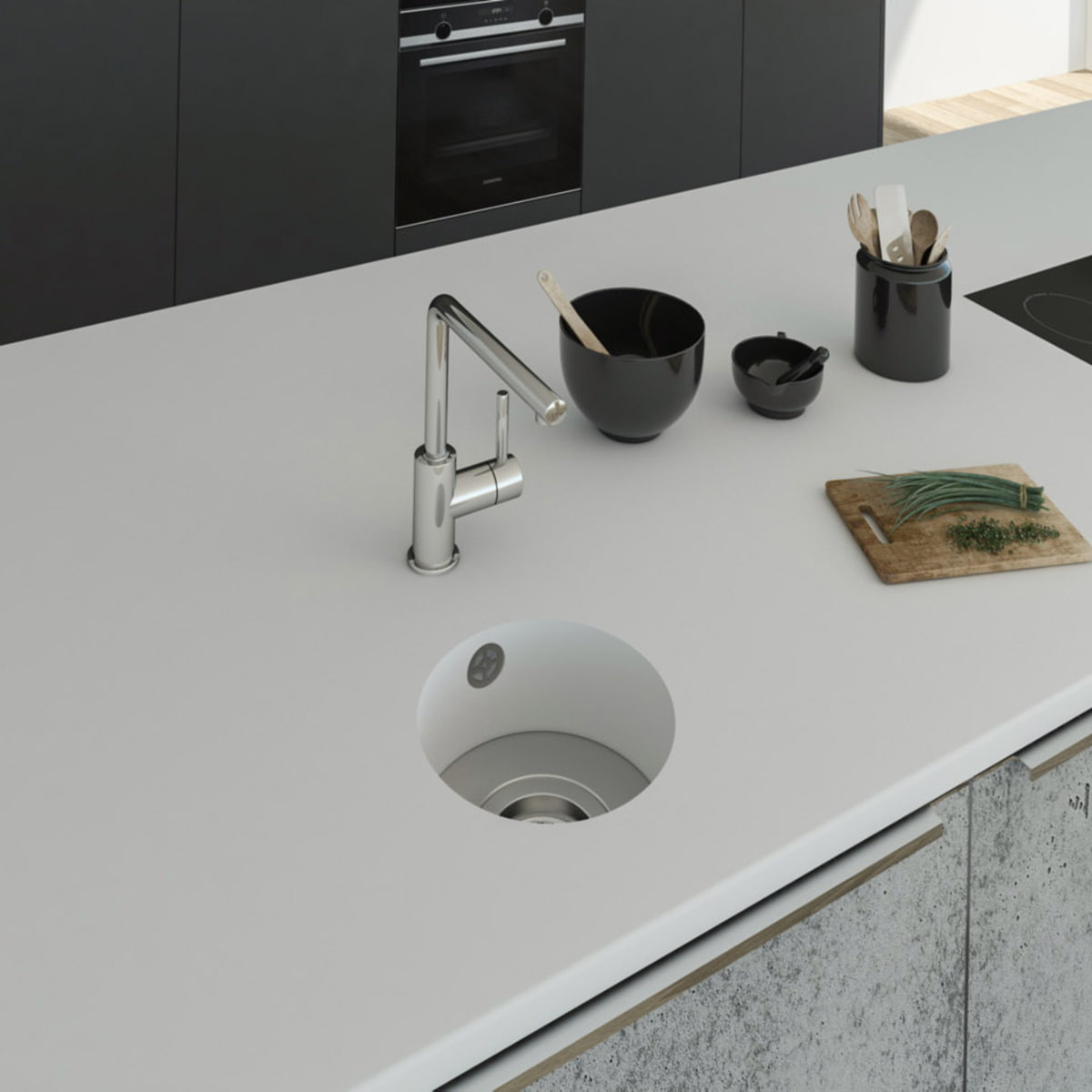Küchenspüle rund PRSE199, Durchmesser 223 mm aus dem Mineralwerkstoff Staron in der Farbe Bright White mit einem Spülenboden aus Edelstahl und einer Ablaufgarnitur. Die Spüle wurde in eine Arbeitsplatte auch aus Staron Bright White fugenlos eingebaut. 