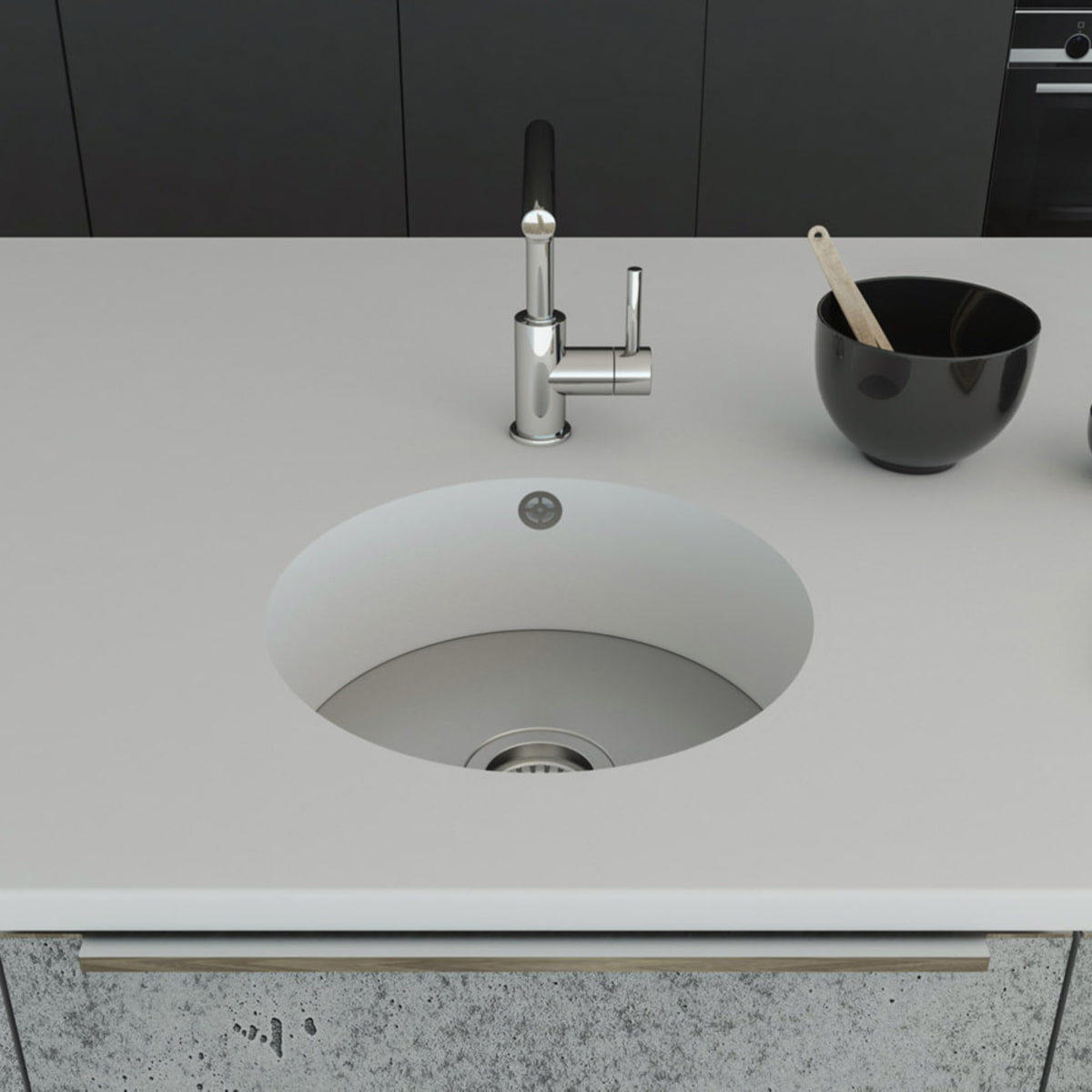 Küchenspüle rund PRSE380, Durchmesser 404 mm aus dem Mineralwerkstoff Staron in der Farbe Bright White mit einem Spülenboden aus Edelstahl und einer Ablaufgarnitur. Die Spüle wurde in eine Arbeitsplatte auch aus Staron Bright White fugenlos eingebaut. 